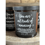 Black jar candle with a label reading "You are all kinds of amazing"
