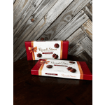 Two boxes of Russell Stover pecan chocolates on a wooden surface