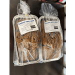 Two wrapped blueberry sweet bread loaves in foil pans