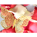 Gold butterfly decoration on red and white flower petals