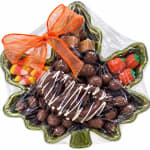 Leaf-shaped gift tray of assorted chocolates wrapped in clear plastic with an orange bow