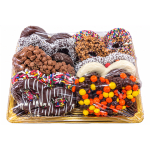 Tray of assorted chocolate-covered donuts and candy under plastic wrap