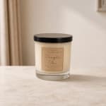 Pumpkin chai candle in a glass jar with a black lid