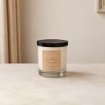 Lavender-scented candle in a glass jar with a black lid