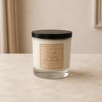 Vanilla pumpkin marshmallow candle in a clear glass jar with a black lid