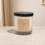 Pumpkin Spice candle in a glass jar with a black lid