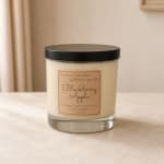 Blackberry Apple soy candle in a clear glass jar with a black lid