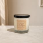 Apple Pumpkin candle in a clear glass jar with a black lid