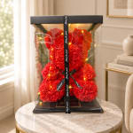 Red rose teddy bear in a clear gift box with a black ribbon