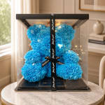 Blue rose teddy bear in a clear gift box with a black ribbon
