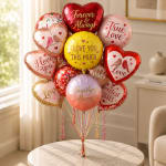 Heart-shaped love balloons in pink, red, and yellow on a table