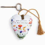 Heart-shaped floral ornament with a key and tassel