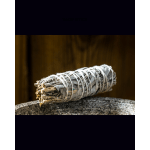 Bundle of dried sage wrapped with string on a stone surface