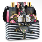 Bath gift set in a striped zippered bag with floral-labeled bottles and jars
