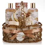 Bath gift set in a woven basket with bottles and a ribbon bow