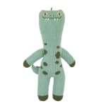 Knitted green dinosaur plush toy with spots and a tail