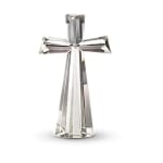 Silver faceted cross figurine on a white background