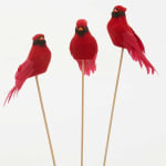 Three red decorative bird picks on wooden sticks