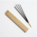 Box of incense sticks beside several loose incense sticks