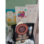 Assorted greeting cards displayed on a shelf, including birthday, get well, sympathy, and thank you cards.