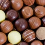 Assorted chocolate truffles in brown, tan, and cream tones