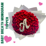 Round bouquet of red roses with a white monogram on white wrap