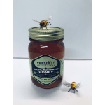 Jar of honey with two decorative bee figurines