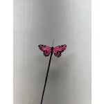 Pink butterfly decoration on a black stem against a plain background