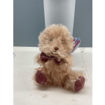 Plush beige teddy with pink accents