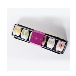 Box of assorted pastel macarons in a black tray