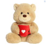 Plush teddy bear holding a red mug with a white heart