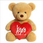 Tan teddy bear holding a red heart pillow with "xoxo" text