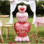 Heart-shaped Valentine's Day balloons stacked outdoors with white drapery