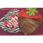 Two Valentine’s Day foil balloons, one strawberry-shaped and one zebra-striped with hearts