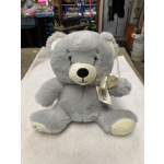 Gray teddy bear with a ribbon bow sitting on a white surface
