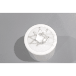 White ceramic container with a silver crown-shaped topper