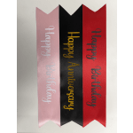 Three birthday ribbon banners in pink, black, and red