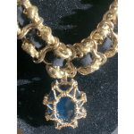 Gold and black with blue and gold pendant