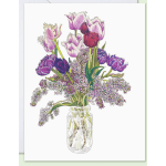 Purple tulips and lilac in a clear glass jar
