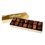 Rectangular gold box of assorted milk and dark chocolates with the lid set behind it