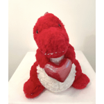 Red plush dinosaur holding a shiny red heart, sitting on a white surface.