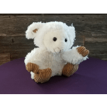 White plush teddy bear with brown corduroy paws sitting on a purple surface