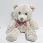Plush teddy bear with a red bow tie