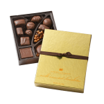 Box of assorted chocolates with a gold lid and brown ribbon