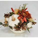 White pumpkin centerpiece with orange flowers and autumn leaves