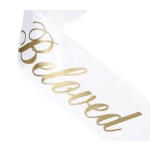 White ribbon with gold script text reading Beloved