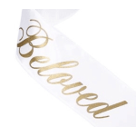White ribbon with gold cursive lettering