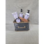 Lavender-scented bath and body gift set in a metal tin with bottles, tube, jar, and sponge