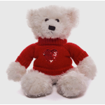 White teddy bear in a red sweater with a heart on the chest