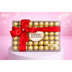 Box of Ferrero Rocher chocolates tied with a red ribbon
